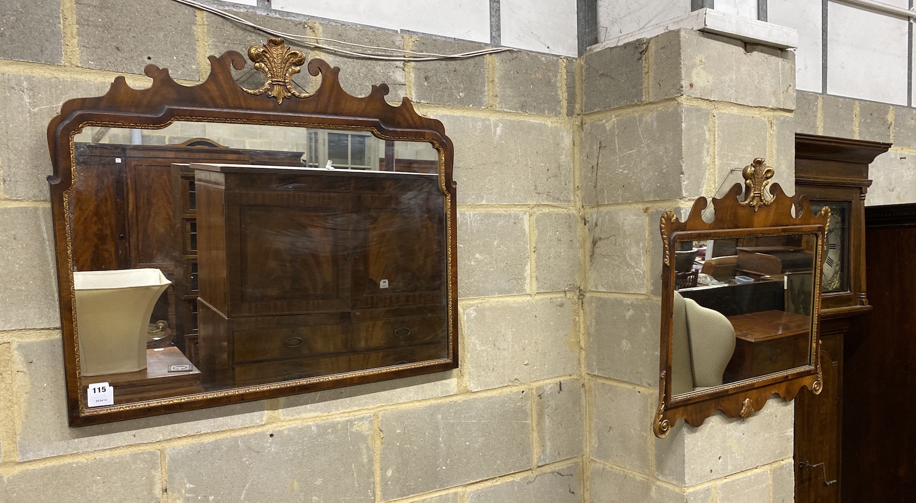 A Queen Anne style parcel gilt fret cut wall mirror, with gilt fleur de lys surmount, together with another, larger mirror width 82cm, height 71cm